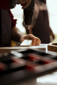 Midsection of man working in workshop