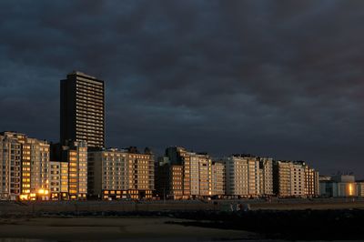 Illuminated buildings against sky at night