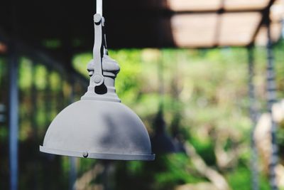 Close-up of electric lamp hanging in yard