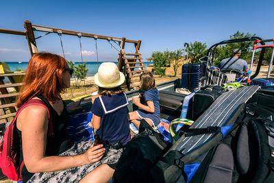 Family at beach against sky