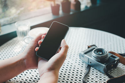 Midsection of man using mobile phone