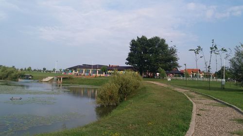 Scenic view of lake by building against sky