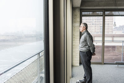 Senior businessman looking out of window