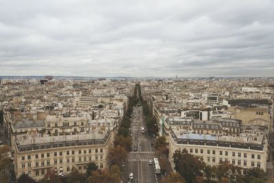 Cityscape against cloudy sky