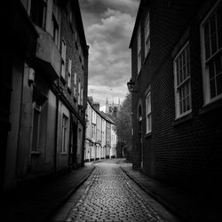 Empty alley amidst buildings in city