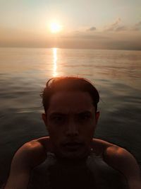 Portrait of man against sea during sunset