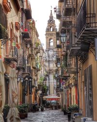 Pathway amidst buildings in city