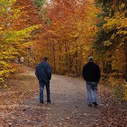 Full length rear view of man with umbrella