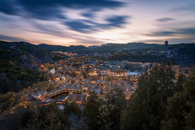 High angle shot of townscape against sky at sunset