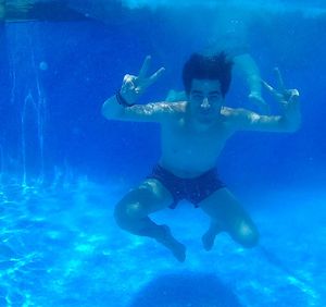 Portrait of young woman swimming underwater