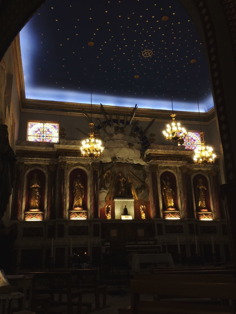 illuminated, architecture, night, built structure, lighting equipment, window, arch, indoors, electric light, entrance, sky, interiors, architectural column, place of worship, famous place, no people, architectural feature