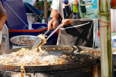 Midsection of man preparing food