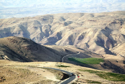 Scenic view of road by mountains