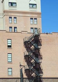 Low angle view of metallic fire escape on residential building