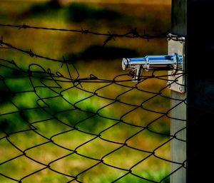 Close-up of chainlink fence against sky