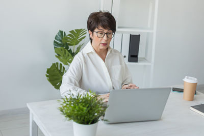 Businesswoman using laptop at home