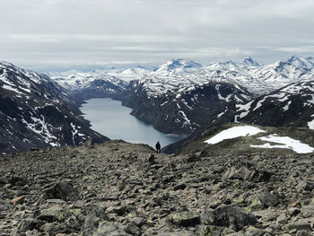 Scenic view of snowcapped norway mountains against sky above lake 