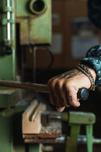 Midsection of man working on wood