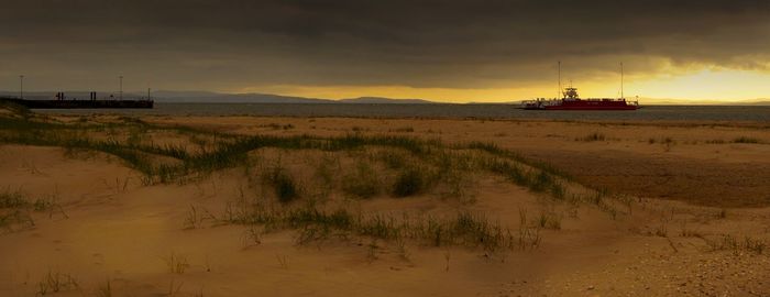 Scenic view of beach against sky during sunset