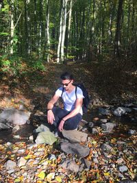 Young woman sitting in forest