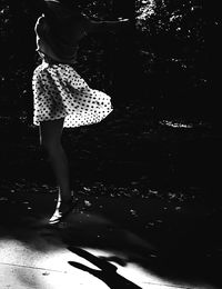 Low section of woman standing in water