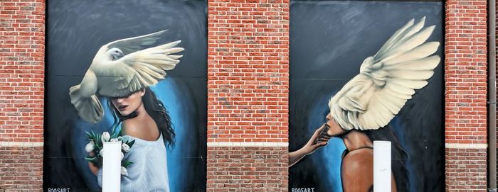 Full length of woman standing against white wall