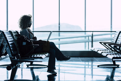 Low section of woman sitting on chair