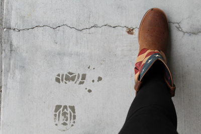 Low section of person standing against wall