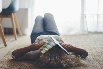 Low section of woman sitting on floor