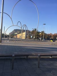 Empty street against clear blue sky