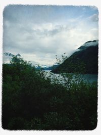 Scenic view of mountains against cloudy sky