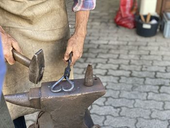 Midsection of man working at workshop