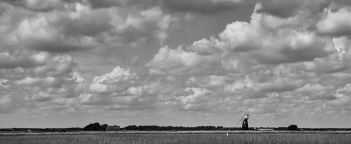 Panoramic shot of man standing on field against sky