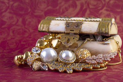 Close-up of jewelries and container on table