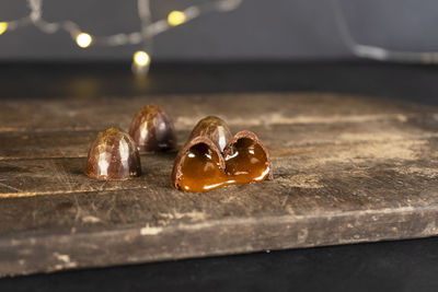 Chocolate candies with liquid filling cut in half. christmas garland background.