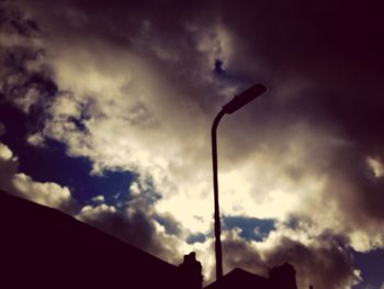 Low angle view of street light against cloudy sky