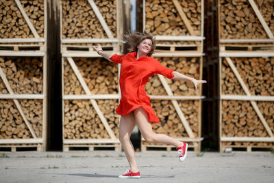 Full length of woman with red umbrella