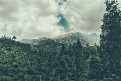 Scenic view of mountains against cloudy sky