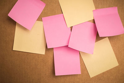 Close-up of blank sticky notes on cardboard box