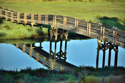 Built structure on field by lake against sky