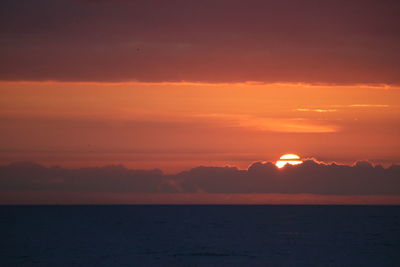 Scenic view of sea against romantic sky at sunset