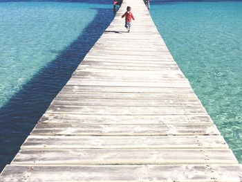 Man walking on pier