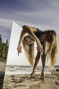 Full length of woman on beach against sky
