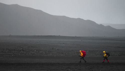 Two hikers in bad weather on the laugavegur hiking trail