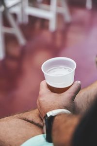 Close-up of hand holding coffee cup