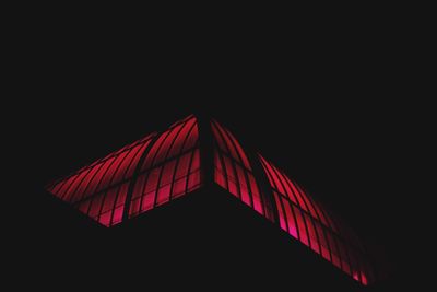 Red umbrella against black background