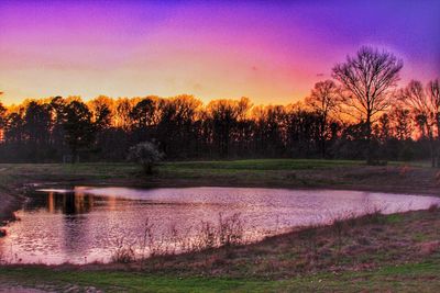 Scenic view of farm against sky during sunset