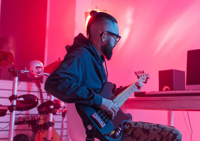 Man playing guitar at music concert