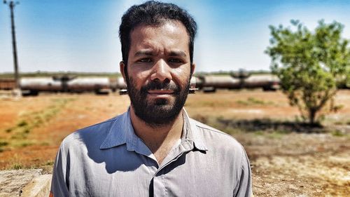 Portrait of man standing on field