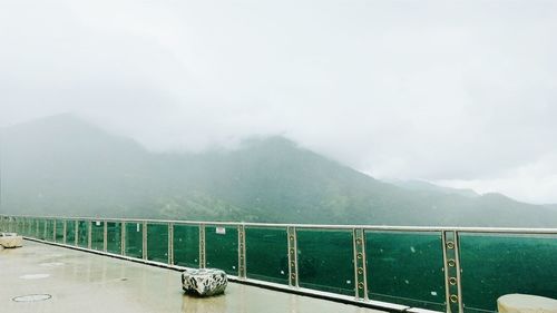 High angle view of mountains against sky during foggy weather